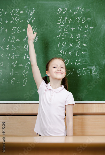 Photo: Pupil knows the answer and puts her hand up Pupil knows the answer and puts her hand up