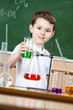 Little chemist shows colored liquid in conical flask