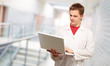 Portrait of a doctor surfing on laptop
