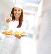 Photo: Woman chef holding baked food Woman chef holding baked food