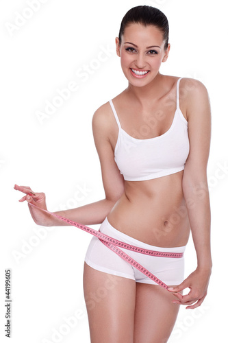 Photo: excited woman standing with measuring tape excited woman standing with measuring tape