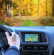 Travel by car with gps in autumnal scenery