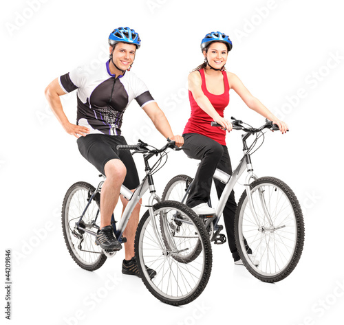 Photo: Full length portraits of young male and female bikers on a bike Full length portraits of young male and female bikers on a bike