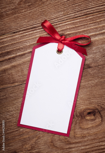 Photo: address card with bow on old wooden background. address card with bow on old wooden background.