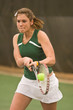Female Tennis Player Hits Backhand Stroke
