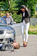 Male thief stealing car, accomplice distracts female driver