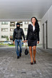 Bandit in mask following businesswoman. Robbery concept