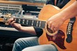 left-handed man playing guitar, close-up
