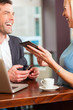 Working colleagues - man and woman - sitting in cafe