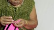 female elder knitting hand close up