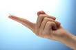 contact lens on finger on blue background