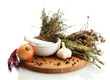 dried herbs in mortar and vegetables, isolatrd on white