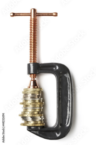 Photo: Coin Currency being squeezed in clamp Coin Currency being squeezed in clamp