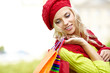 Autumn woman carrying shopping bags walking city street