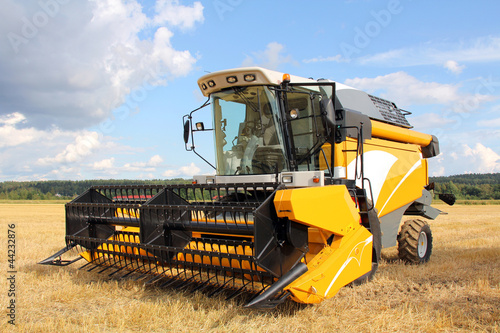 Photo: Modern Combine Harvester on Field Modern Combine Harvester on Field