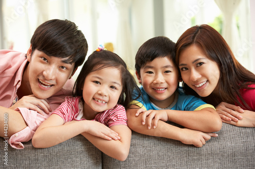 Photo: Chinese Family Sitting And Relaxing On Sofa Together At Home Chinese Family Sitting And Relaxing On Sofa Together At Home