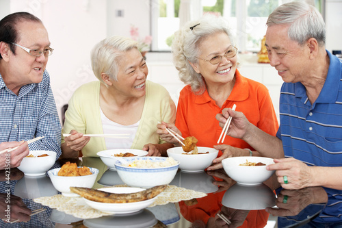 Photo: Group Of Senior Chinese Friends Eating Meal At Home Group Of Senior Chinese Friends Eating Meal At Home