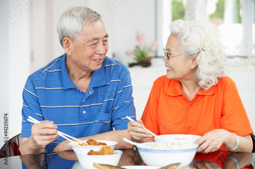 Photo: Senior Chinese Couple Sitting At Home Eating Meal Senior Chinese Couple Sitting At Home Eating Meal