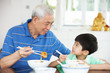 Photo: Chinese Grandfather And Grandson Eating Meal Together Chinese Grandfather And Grandson Eating Meal Together