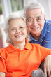 Senior Chinese Couple Relaxing On Sofa At Home