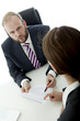 Photo: beard business man brunette woman at desk sign contract beard business man brunette woman at desk sign contract