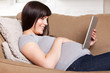 Happy Pregnant Woman with Digital Tablet