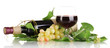bottle of wine with grape leaves isolated on white