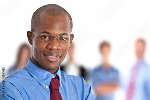 Photo: Businessman in front of his team Businessman in front of his team