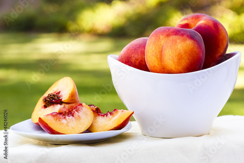 Photo: Sliced peach and bowl full of peaches Sliced peach and bowl full of peaches
