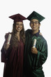 graduates in cap and gown with diplomas