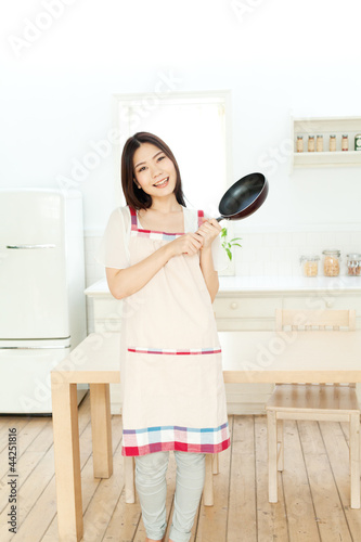 Photo: Beautiful young woman relaxing in kitchen Beautiful young woman relaxing in kitchen