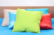 bright pillows on bed on white background