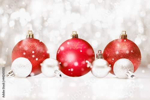 Photo: Christmas baubles in falling snow Christmas baubles in falling snow