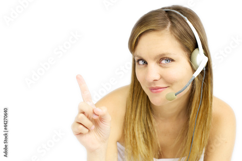 Photo: Attractive blond girl with headset shows your text Attractive blond girl with headset shows your text