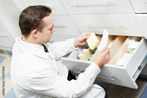 Photo: Confident pharmacy chemist man in drugstore Confident pharmacy chemist man in drugstore