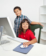 Photo: Young Boy and Girl Smiling Learning Computer Skills Young Boy and Girl Smiling Learning Computer Skills