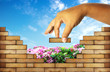 hand building a brick wall ;build a house concept