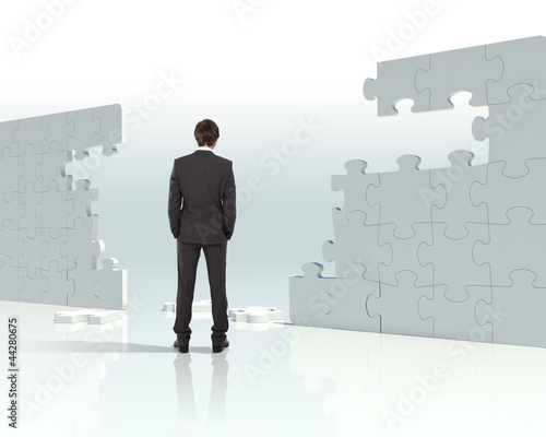 Photo: Businessman with a puzzle pieces Businessman with a puzzle pieces