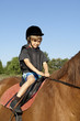 young boy ride a horse