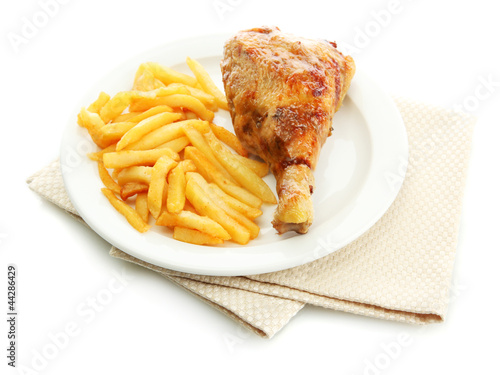 Photo: Roast chicken with french fries on plate, isolated on white Roast chicken with french fries on plate, isolated on white