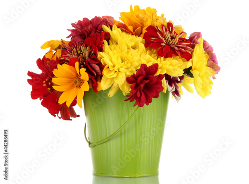 Photo: bouquet of beautiful summer flowers in bucket, isolated on bouquet of beautiful summer flowers in bucket, isolated on