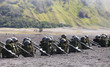 Photo: army package of guns, backpacks and helmet in mountain army package of guns, backpacks and helmet in mountain