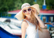 Beautiful young woman in hat outdoors