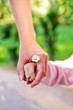 Photo: Hands of mother and daughter holding each other. Hands of mother and daughter holding each other.