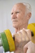 Senior man doing exercises with a dumbbell
