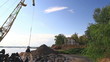 Floating crane digging sand on river side