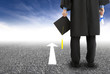 graduate standing on the road and forward arrow