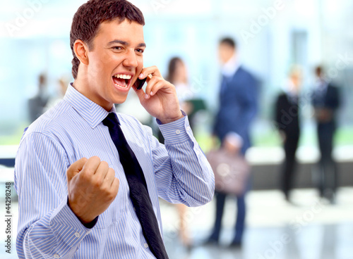 Photo: Portrait of happy businessman talking on mobile Portrait of happy businessman talking on mobile