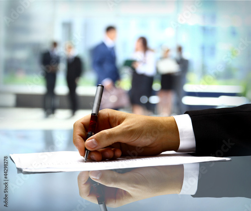 Photo: Businessman is signing a contract Businessman is signing a contract