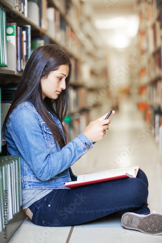 Photo: Hispanic student texting Hispanic student texting